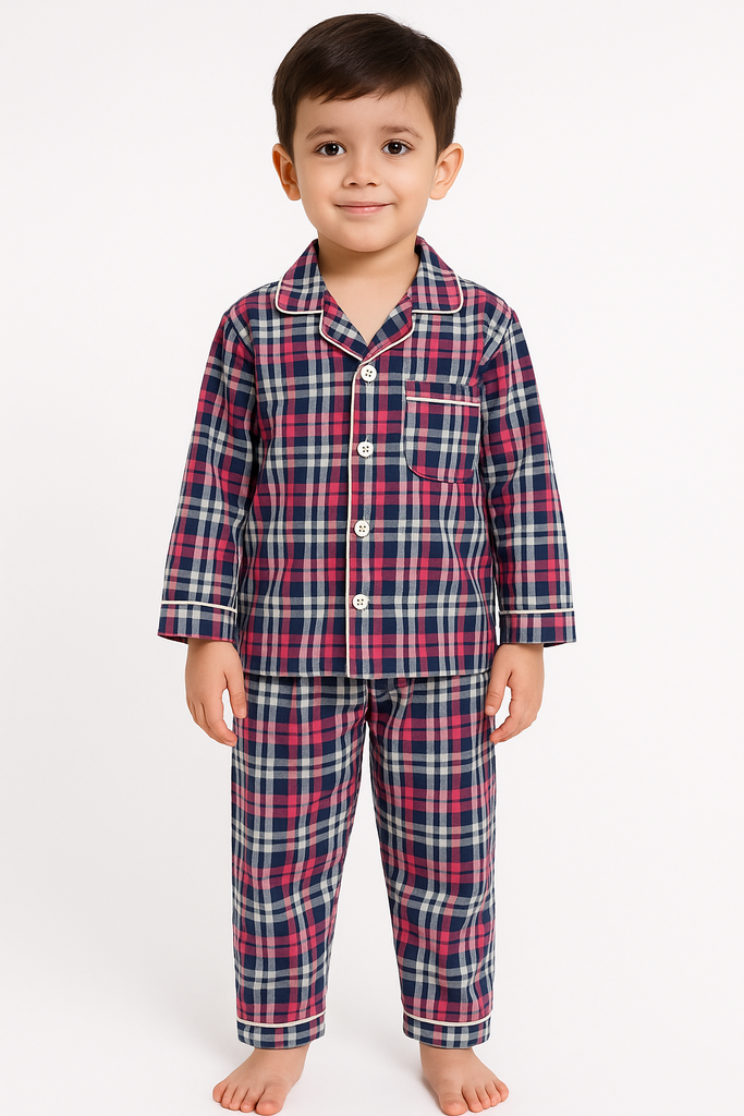 Child wearing a red and blue plaid pajama set on a white background