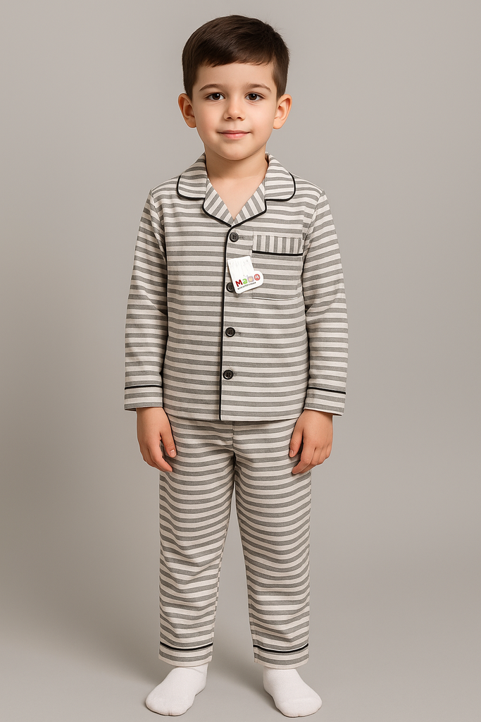 Child wearing a gray and white striped pajama set on a plain background