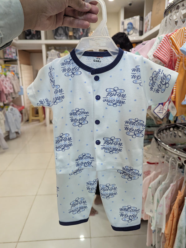 Baby romper with text on a hanger in a store setting